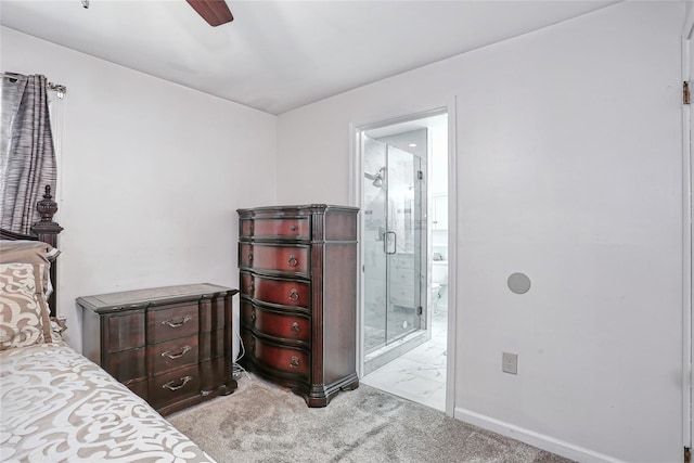 bedroom featuring light carpet, ceiling fan, ensuite bathroom, and baseboards