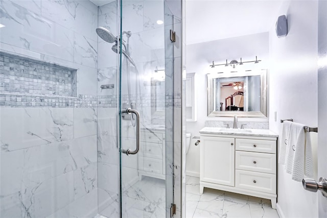 full bath with vanity, a shower stall, and marble finish floor