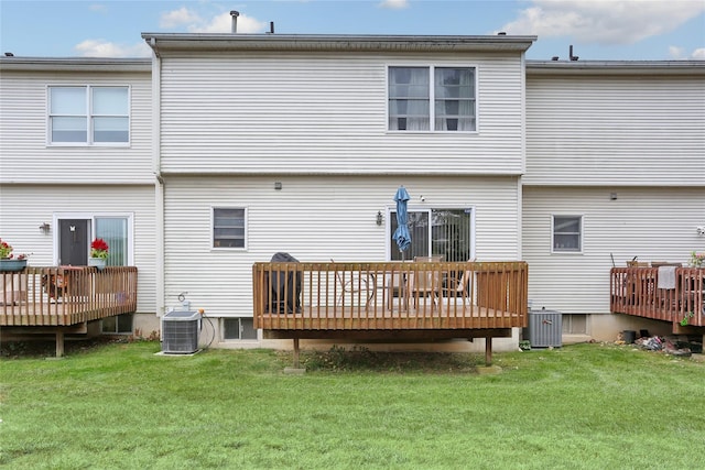 rear view of property featuring central air condition unit, a yard, and a deck