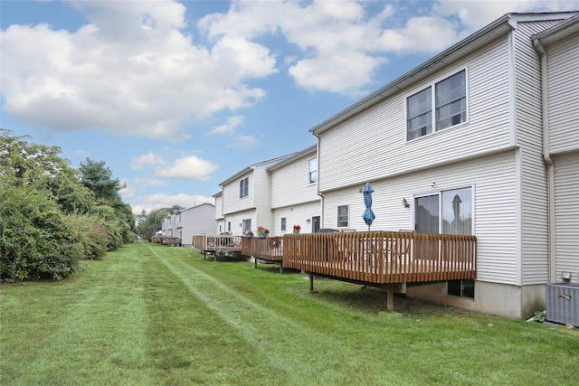 back of house featuring a yard, central AC unit, and a wooden deck