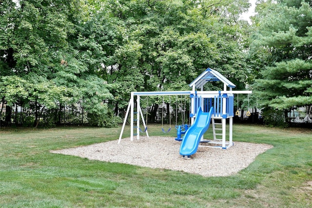 view of jungle gym with a yard and fence