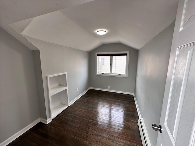 bonus room featuring a baseboard radiator, lofted ceiling, baseboards, and wood finished floors