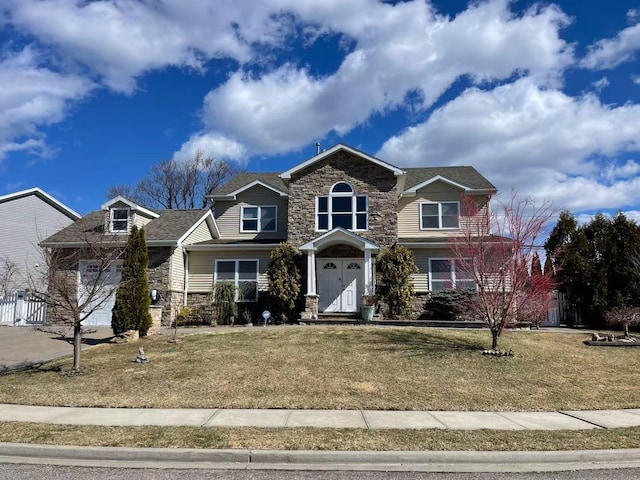 view of front facade with stone siding and a front yard