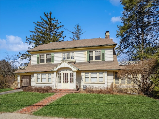 view of front of property featuring a chimney and a front lawn