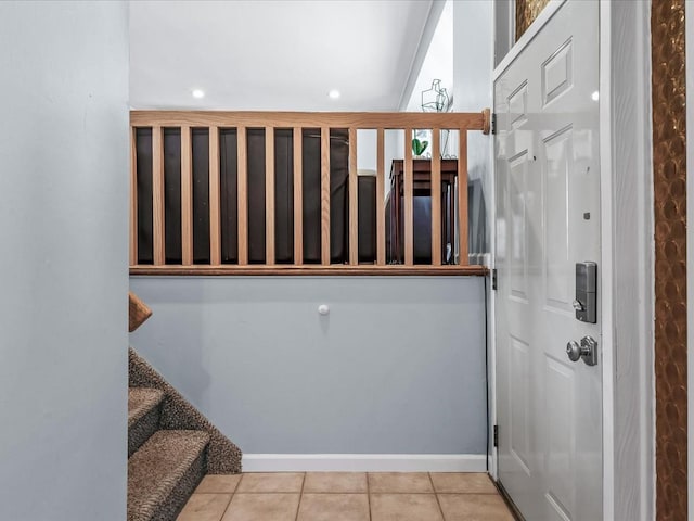 staircase featuring recessed lighting, baseboards, and tile patterned flooring