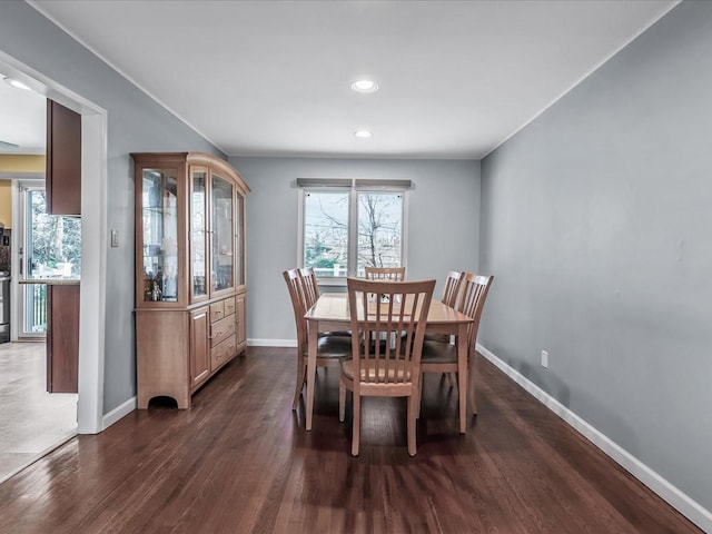 dining space with plenty of natural light, dark wood-style floors, and baseboards