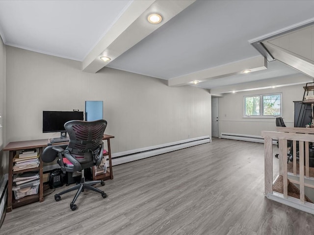 office space with a baseboard heating unit, baseboard heating, wood finished floors, and crown molding