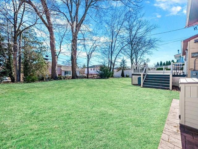 view of yard with stairway and a deck