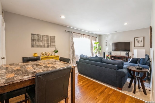 living area with recessed lighting and wood finished floors