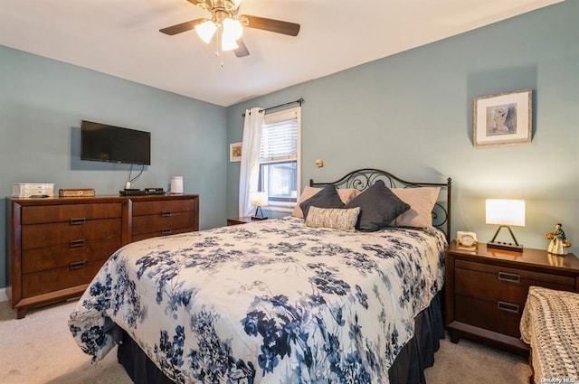 bedroom with light colored carpet and a ceiling fan