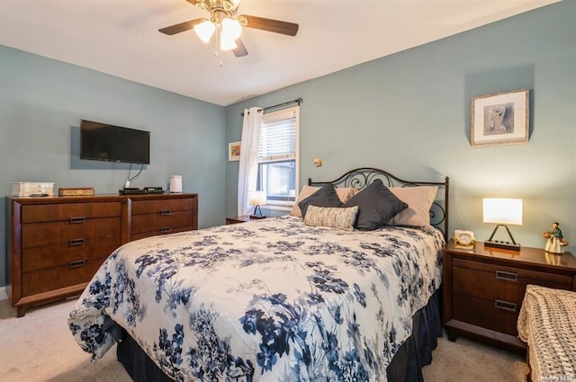 bedroom featuring light carpet and a ceiling fan