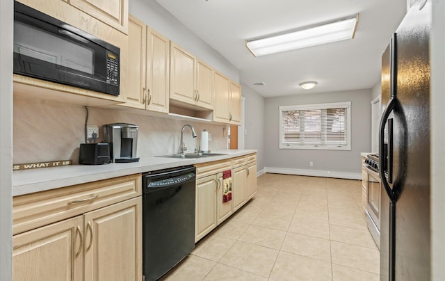 kitchen featuring light tile patterned floors, light brown cabinets, a sink, decorative backsplash, and black appliances