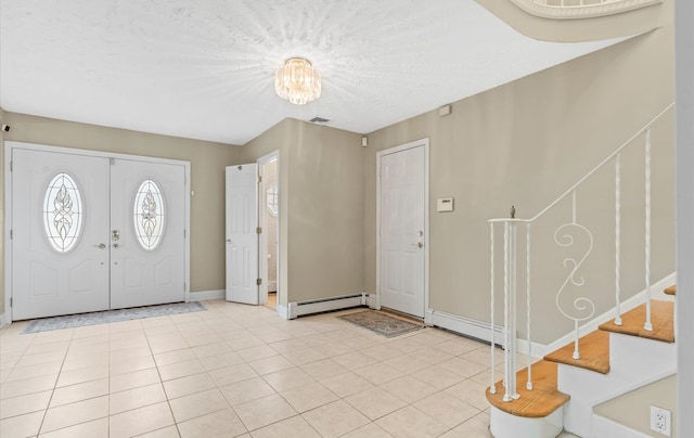 entrance foyer featuring light tile patterned floors, baseboards, stairway, and baseboard heating