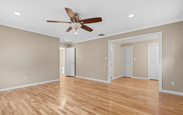 empty room featuring crown molding, recessed lighting, light wood-style flooring, and baseboards