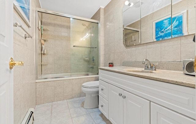 full bath featuring tile walls, decorative backsplash, a baseboard heating unit, tiled shower / bath combo, and vanity