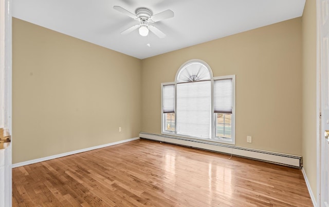 empty room with baseboards, a baseboard radiator, a ceiling fan, and wood finished floors