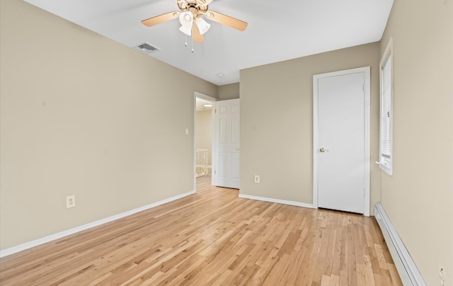 unfurnished bedroom with visible vents, baseboards, ceiling fan, light wood-style flooring, and baseboard heating