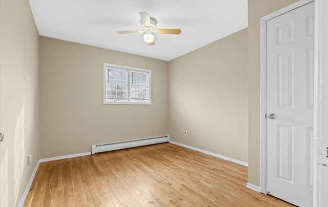 unfurnished bedroom featuring baseboard heating, light wood-type flooring, a ceiling fan, and baseboards