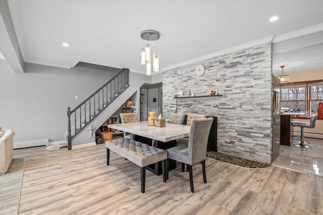 dining room with stairs, wood finished floors, baseboards, and ornamental molding