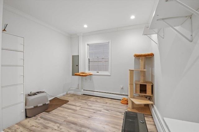 interior space featuring wood finished floors, electric panel, recessed lighting, crown molding, and baseboard heating