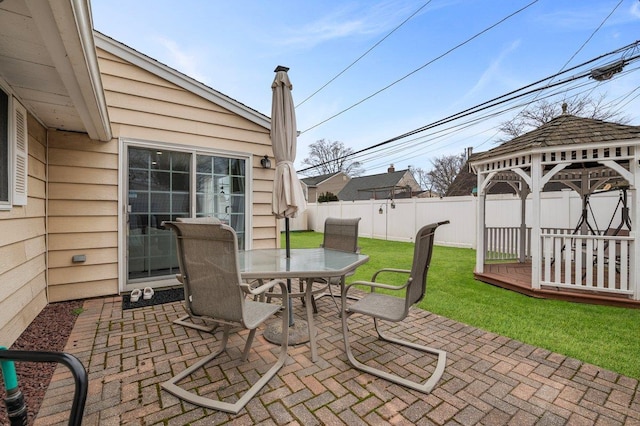 view of patio / terrace with a gazebo, outdoor dining area, and a fenced backyard