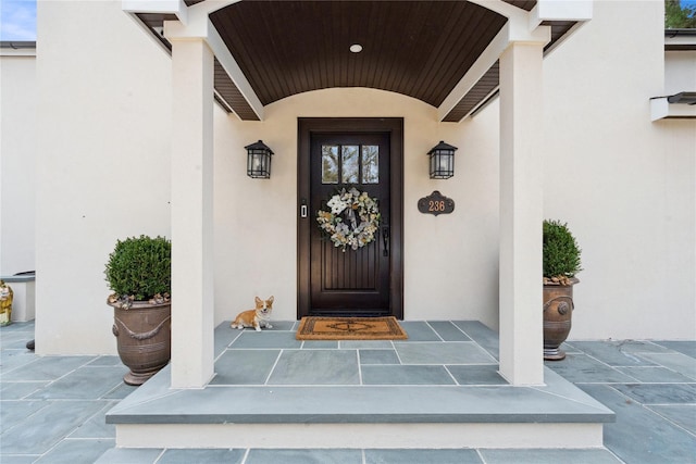 property entrance with stucco siding