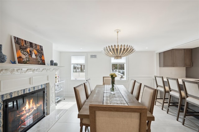 dining area with visible vents, a notable chandelier, recessed lighting, light tile patterned floors, and a premium fireplace