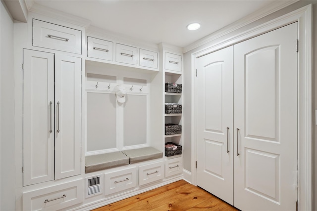 mudroom featuring light wood finished floors, visible vents, and recessed lighting