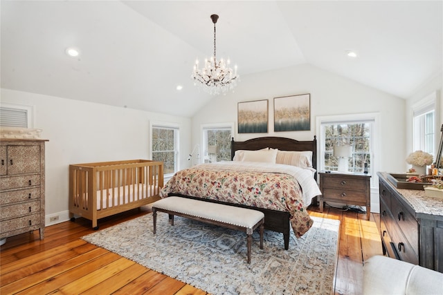 bedroom with recessed lighting, light wood finished floors, an inviting chandelier, and vaulted ceiling