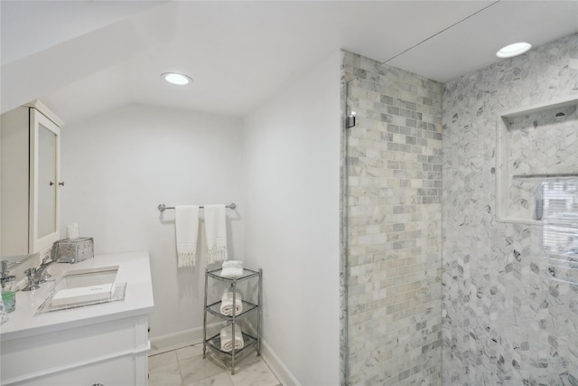 bathroom featuring baseboards, vaulted ceiling, a tile shower, recessed lighting, and vanity