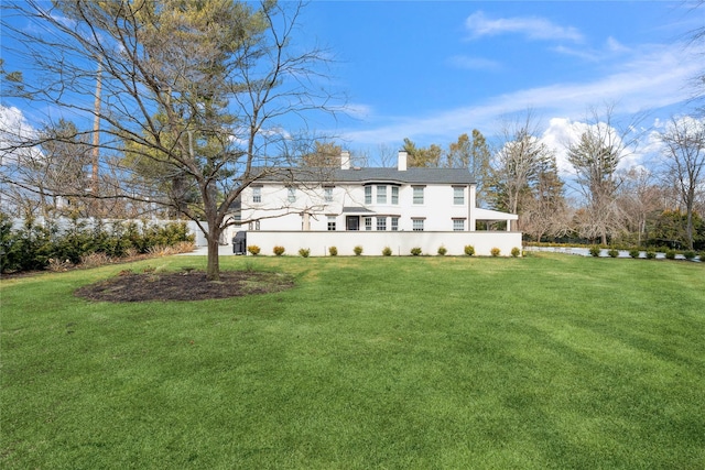 view of front of home with a front lawn and a chimney