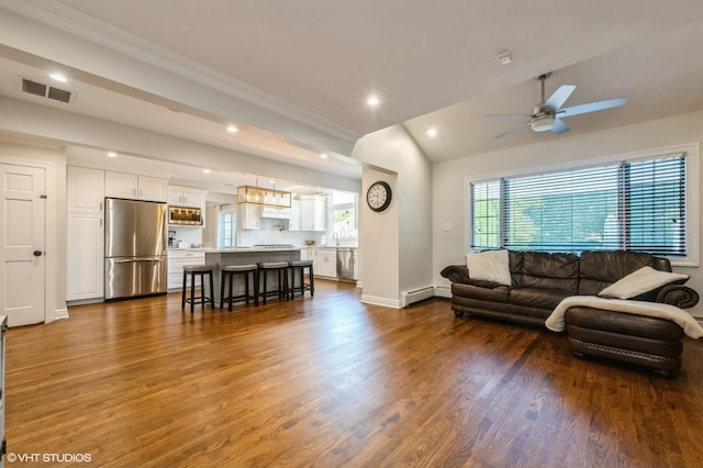living area with visible vents, vaulted ceiling, dark wood finished floors, ornamental molding, and recessed lighting