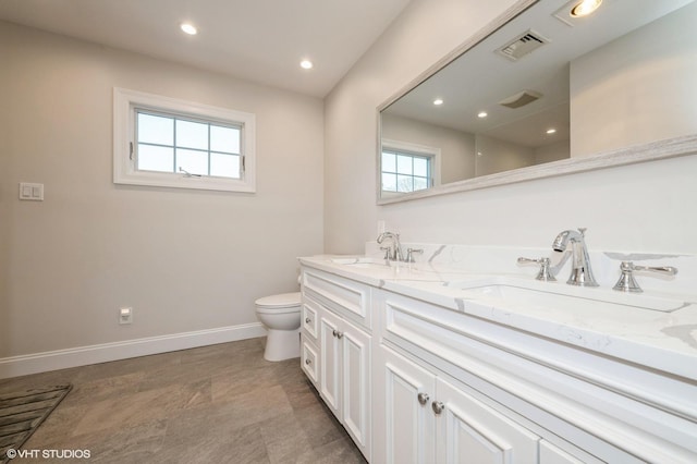 full bath featuring a sink, baseboards, toilet, and visible vents