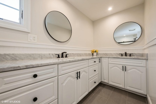 full bathroom featuring a sink, tile patterned flooring, and double vanity