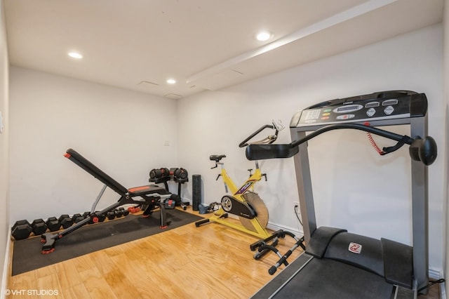 workout area featuring recessed lighting, baseboards, and wood finished floors