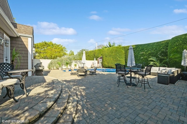 view of patio with a fenced in pool, a fenced backyard, outdoor dining area, and an outdoor hangout area
