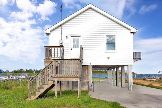 rear view of house with a carport and stairway