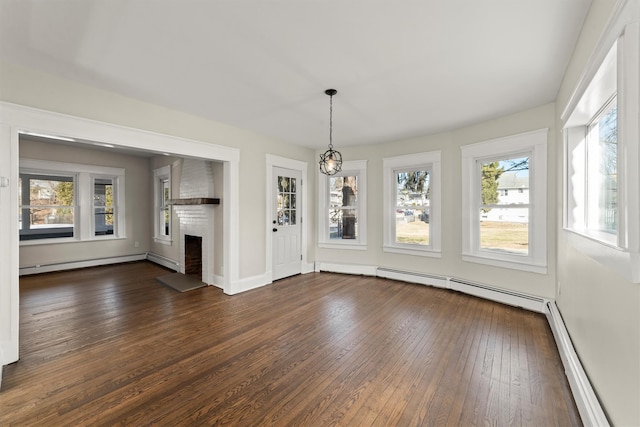 unfurnished living room featuring dark wood-style floors, baseboards, a baseboard radiator, a fireplace, and a baseboard heating unit