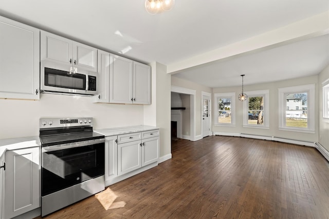 kitchen with dark wood-style floors, stainless steel appliances, white cabinets, a fireplace, and baseboards