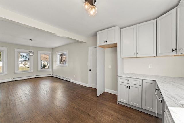 kitchen with dark wood-style floors, white cabinets, hanging light fixtures, baseboards, and light stone countertops