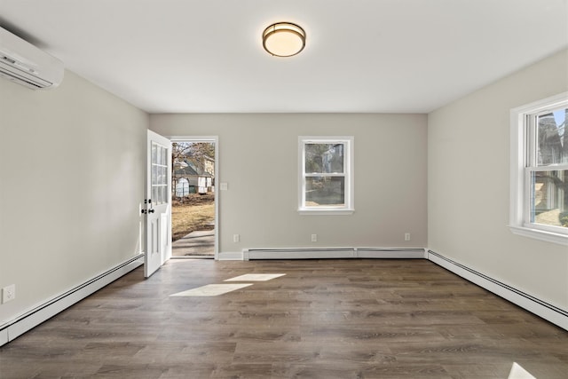 spare room with a wealth of natural light, a baseboard radiator, and a wall unit AC