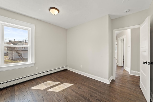 empty room featuring a baseboard radiator, baseboards, and dark wood-style floors