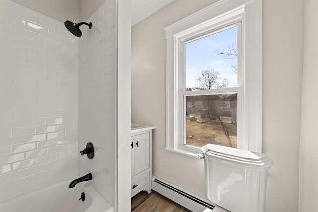 full bath featuring a wealth of natural light, baseboard heating, tub / shower combination, and vanity