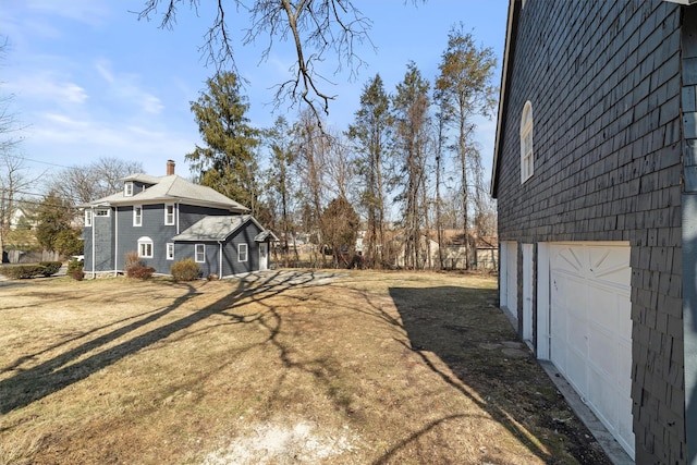 view of home's exterior with a yard and a chimney