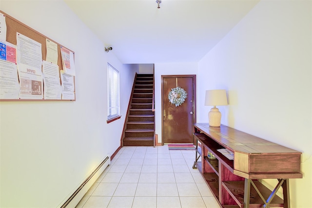 entrance foyer with light tile patterned floors, baseboard heating, and stairs