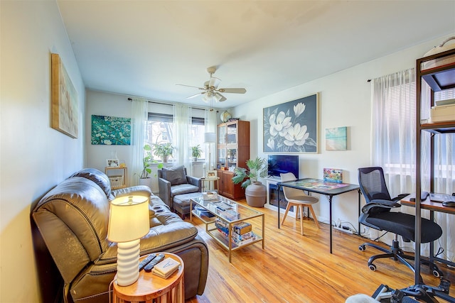 living room featuring a ceiling fan and light wood-style floors