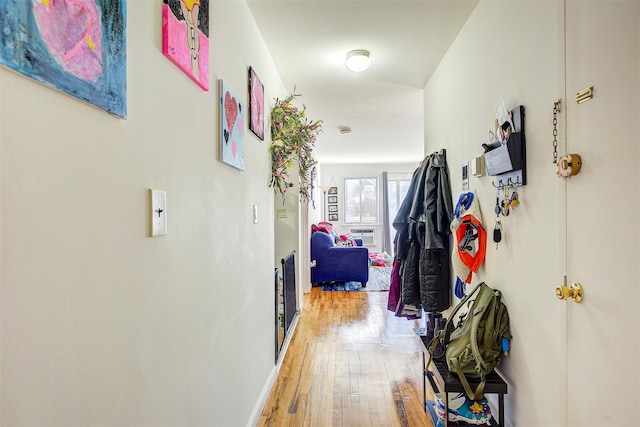 hallway with light wood-style flooring and baseboards