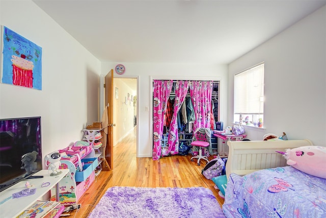 bedroom with a closet and wood finished floors