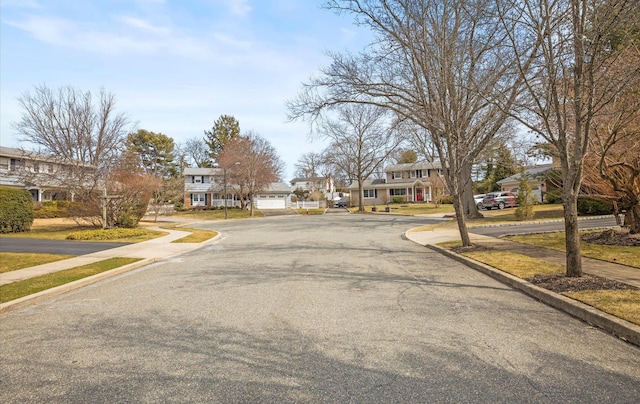 view of street featuring curbs, sidewalks, and a residential view