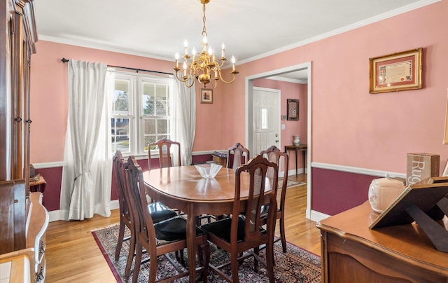 dining space featuring baseboards, light wood-style floors, and ornamental molding